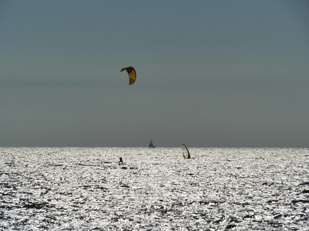 Image of Kitesurfing at Paje Beach during Kaskazi season:
"Kitesurfer riding the steady northeasterly winds at Paje Beach during the Kaskazi season in Zanzibar."
Image of Nungwi Beach during Kuzi season:
"Advanced kitesurfer tackling strong southeast winds at Nungwi Beach during the Kuzi season in Zanzibar."
Image of Paje Beach on a calm day during the shoulder season:
"Kitesurfers enjoying a quiet day at Paje Beach during the shoulder season with light winds."
Image of a sunset kitesurfing session:
"Kitesurfer gliding across the water during a stunning sunset on a calm day in Zanzibar."